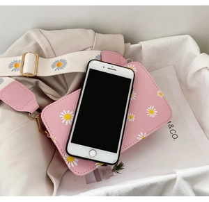 Pink daisy print square crossbody bag with wide strap and phone for size comparison