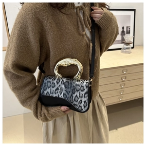 Fashionable leopard print handbag with a unique gold irregular handle and plush flap cover