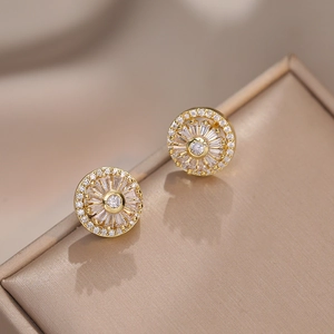 Sparkling sunflower stud earrings with rotating cubic zirconia on a jewelry box