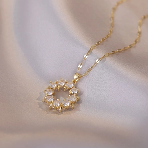 Elegant gold necklace with a sparkling round zircon flower pendant on champagne silk