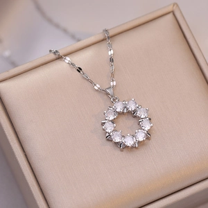 Elegant silver donut circle pendant necklace with zircon stones on a jewelry box