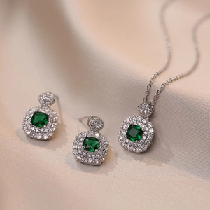 Elegant emerald cut green zircon jewelry set with square pendant and earrings on pink silk