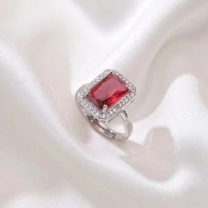 Adjustable silver ring with rectangle red gemstone and white zircon halo on white silk