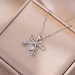 Elegant silver necklace with a bow knot design and sparkling heart-shaped zircon pendant