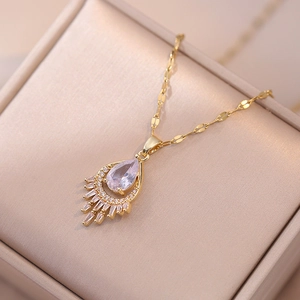 Luxurious gold necklace with pear-shaped zircon pendant on champagne satin jewelry box