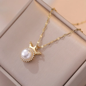 Elegant gold crown pearl necklace with zircon inlay on luxury champagne jewelry box