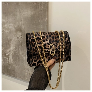 Detailed view of leopard print crossbody bag featuring gold chain and oval metal lock