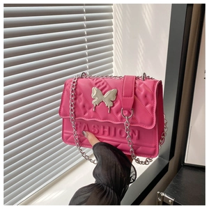 Detail of rose pink crossbody bag with silver butterfly clasp and 3D fashion lettering
