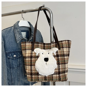 Dettaglio della borsa tote a scacchi con patch di cane soffice e manici in pelle marrone