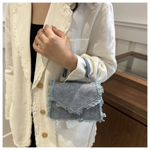 Retro light blue denim crossbody bag with fringe tassels and silver chain strap for women