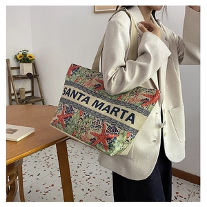 Detail of canvas tote bag with ocean prints and Santa Marta embroidery for women