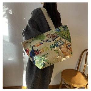 Detail of canvas tote bag featuring tropical leopard print and Santa Marta embroidery