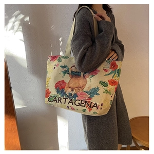 Detail view of large floral canvas tote bag with sloth print and wide shoulder strap