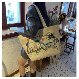Detail of woven jute tote bag with Cartagena tropical print and embroidered texture