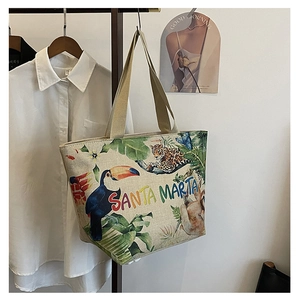 Detailed close-up of tropical canvas tote bag with vibrant animal prints and rainbow text