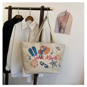 Detail of canvas tote bag with Santa Marta beach print and vintage embroidery