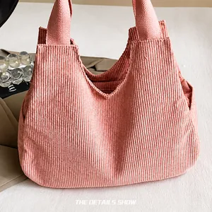 Detail shot of the pink corduroy tote bag showing soft vertical ribbed fabric texture