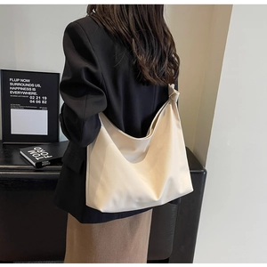 Minimalist beige litchi pattern hobo tote bag with knotted shoulder strap detail