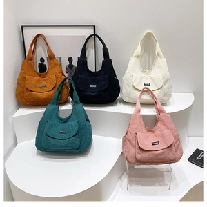 Minimalist corduroy tote bags for women in five colors displayed on a white podium