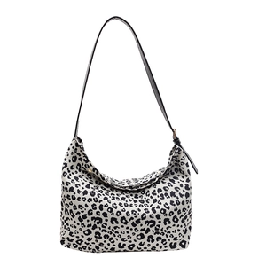 Minimalist leopard print half-moon tote bag with adjustable black shoulder strap