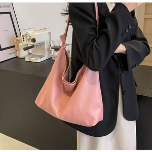 Pink slouchy faux leather tote bag with knot details on shoulder strap for women