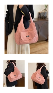 Detail of pink corduroy tote bag showing front pocket and soft textured fabric details