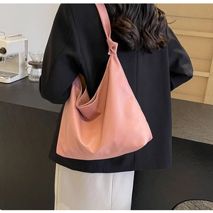 Detailed view of pink soft PU leather tote bag with elegant shoulder strap knot decoration