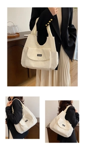 Detail of cream corduroy tote bag with textured stripes and QIANNING logo patch