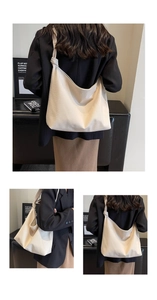 Detail of off-white lychee texture leather hobo bag with unique knotted strap design