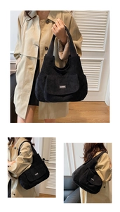 Detail view of black corduroy tote bag featuring front pocket and QIANNING brand label
