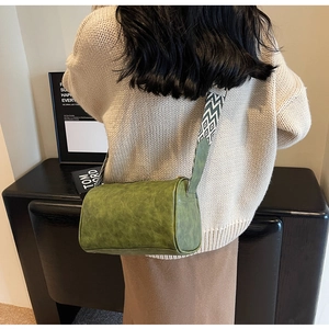 Retro green cylinder bag detail with geometric pattern wide fabric shoulder strap