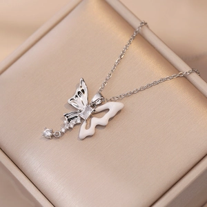 Elegant butterfly pendant necklace with silver tassel and cubic zirconia on jewelry box
