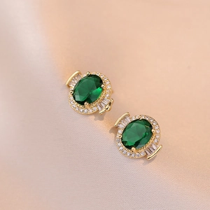 Vintage emerald-style stud earrings with oval cut green gemstone and gold plating