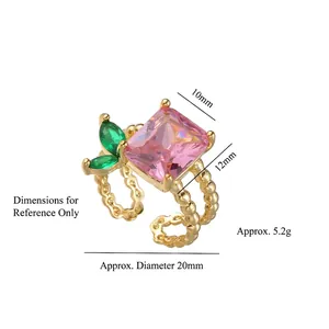 Adjustable gold ring with large pink rectangular gemstone and green marquise side stones