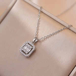 Exquisite silver necklace with a rectangular zircon pendant on a silk jewelry box