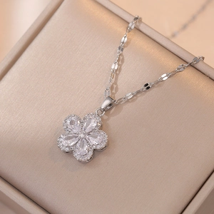 Elegant silver flower pendant necklace featuring teardrop zircons on a champagne box