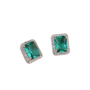 Elegant emerald cut green zircon stud earrings with silver frame on white background