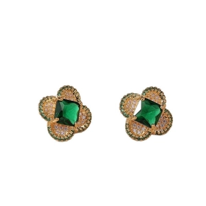 Elegant gold four-leaf clover earrings with emerald-cut green stone and sparkling crystals