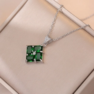 Elegant emerald-green square zircon pendant necklace on luxury champagne silk