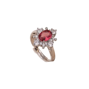 Adjustable silver ring featuring an oval red zircon center with floral halo detail