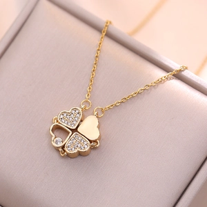 Golden clover folding heart necklace with zircon crystals in a luxury jewelry box