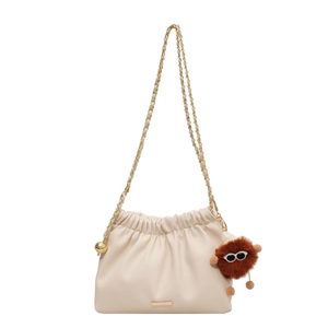 Chic off-white cloud bucket bag with gold chain strap and plush monster charm