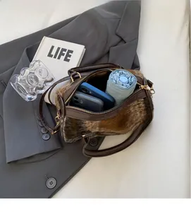 Interior view of leopard print faux fur handbag showing space for phones and umbrella