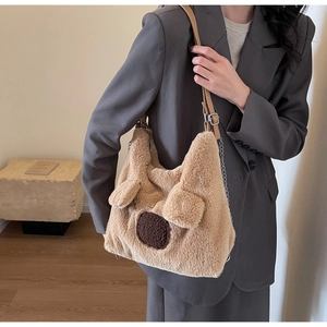 Detail of plush bear-shaped shoulder bag featuring soft faux fur and chain strap styling