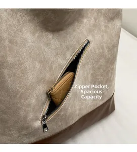 Detail of vintage patchwork tote featuring a diagonal zipper pocket and contrast leather