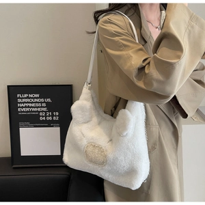 Detail of white plush shoulder bag featuring cute 3D ears and soft faux fur texture