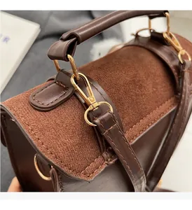 Close-up of caramel brown leather backpack with gold hardware and stitching details