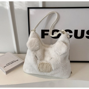 Detail of white plush pig-shaped handbag featuring unique textures and leather strap