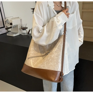Close-up of vintage large tote bag with contrast stitching and cracked leather texture