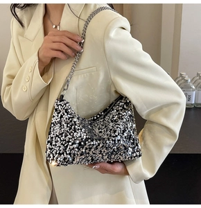 Detail shot of shimmering silver sequins and elegant metal chain strap on the tote bag